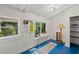 Bright sunroom features blue floors, white walls, two windows, and storage space at 269 Red Gate Dr, Canton, GA 30115