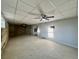 Unfinished basement offers a blank canvas with concrete floor and ceiling fans, ready for customization at 71 Tobinleigh Ct, Acworth, GA 30101