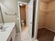 Bathroom featuring a sink and toilet that leads to a walk-in closet at 71 Tobinleigh Ct, Acworth, GA 30101