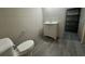 Unfinished bathroom with new floor, toilet, vanity, and roughed-in plumbing awaits your personal design touch at 71 Tobinleigh Ct, Acworth, GA 30101