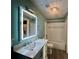 Bright bathroom features vanity with quartz countertop, elegant mirror, and tub shower combination at 71 Tobinleigh Ct, Acworth, GA 30101