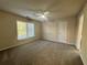 Spacious bedroom featuring large window and a ceiling fan at 71 Tobinleigh Ct, Acworth, GA 30101