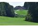 View of home on golf course with lush landscaping and exterior porch at 71 Tobinleigh Ct, Acworth, GA 30101