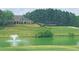 Exterior view of home overlooking a pond with fountain, beautiful lush green lawn, and trees at 71 Tobinleigh Ct, Acworth, GA 30101