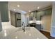 Modern kitchen featuring a large island with a sink, quartz countertops, stainless steel appliances, and custom cabinets at 71 Tobinleigh Ct, Acworth, GA 30101