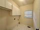 Laundry room featuring overhead cabinets and tile floors at 71 Tobinleigh Ct, Acworth, GA 30101