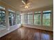 Bright sunroom with large windows providing wooded views and hardwood floors at 71 Tobinleigh Ct, Acworth, GA 30101