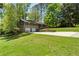 A stunning home with an attached two-car garage and well-manicured lawn surrounded by lush trees at 3105 Sumac Dr, Atlanta, GA 30360