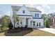 Charming two-story home with white siding, brick accents, well-manicured lawn, and inviting covered porch at 602 Belshire Dr, Acworth, GA 30102