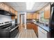 Well-lit kitchen features wood cabinets, mosaic backsplash, stainless-steel appliances and vinyl flooring at 244 Pauladean Se Cir, Marietta, GA 30067