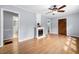 Living room boasting wood floors, ceiling fan, and a charming fireplace at 244 Pauladean Se Cir, Marietta, GA 30067