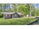 Quaint single-story house on a green lawn with covered carport, surrounded by mature trees at 3917 Dallas Acworth Nw Hwy, Acworth, GA 30101