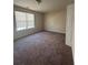 Spacious bedroom with a large window for natural light, neutral walls, and plush carpeting at 4194 Wesley Ln, Decatur, GA 30035