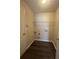 Functional laundry room featuring wood-look flooring, storage shelving, and utility connections at 4194 Wesley Ln, Decatur, GA 30035