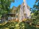 Spacious backyard with lush lawn, mature trees, and back porch at 610 Brington Close, Alpharetta, GA 30022