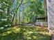 Lush backyard featuring mature trees and wooden steps at 610 Brington Close, Alpharetta, GA 30022
