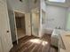 Bathroom featuring wood-look flooring, separate tub and shower, and a vanity at 610 Brington Close, Alpharetta, GA 30022