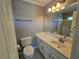 Bathroom featuring a tiled shower/tub combo, a toilet, and a single sink vanity at 610 Brington Close, Alpharetta, GA 30022