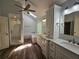 Modern bathroom featuring wood look tile, skylight, and double sink vanity at 610 Brington Close, Alpharetta, GA 30022