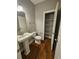 Bathroom with a pedestal sink, open door to the pantry, and toilet at 610 Brington Close, Alpharetta, GA 30022