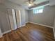 Cozy bedroom with wood-look flooring, a ceiling fan, and a closet, creating a comfortable private space at 610 Brington Close, Alpharetta, GA 30022