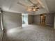 Spacious carpeted bedroom featuring a tray ceiling and neutral wall color at 610 Brington Close, Alpharetta, GA 30022