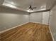 A bedroom featuring tray ceiling, ceiling fan, and wood-look floors at 610 Brington Close, Alpharetta, GA 30022