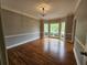 Well-lit dining room featuring bay window and hardwood floors at 610 Brington Close, Alpharetta, GA 30022
