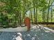 Driveway and entrance to a charming home with mature trees and partial fence at 610 Brington Close, Alpharetta, GA 30022