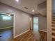 Spacious hallway with wood floors, neutral walls, and access to rooms with natural light and ceiling fan at 610 Brington Close, Alpharetta, GA 30022