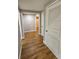 Bright hallway features sleek wood floors, white doors, and neutral walls for a modern, clean aesthetic at 610 Brington Close, Alpharetta, GA 30022
