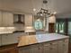 Kitchen with granite countertops, white cabinets, a butcher block island, and stainless steel appliances at 610 Brington Close, Alpharetta, GA 30022