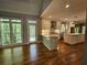 Bright kitchen features white cabinets, stainless appliances, hardwood floors, and large windows offering scenic views at 610 Brington Close, Alpharetta, GA 30022