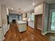 Spacious kitchen with hardwood floors, white cabinets, stainless appliances, and an open layout at 610 Brington Close, Alpharetta, GA 30022