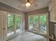 Laundry room with tile floors, white cabinets, lots of natural light, and a ceiling fan at 610 Brington Close, Alpharetta, GA 30022
