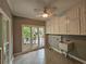 Laundry room with tile floor, white cabinets, a utility sink and large windows overlooking the exterior at 610 Brington Close, Alpharetta, GA 30022