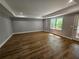 Bright living room with wood floors, recessed lighting, and a large window, creating an inviting space at 610 Brington Close, Alpharetta, GA 30022