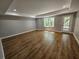 Bright living room featuring wood floors, recessed lighting, and a glass door providing access to outdoor space at 610 Brington Close, Alpharetta, GA 30022