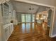 Living room with hardwood floors open to kitchen with fireplace at 610 Brington Close, Alpharetta, GA 30022