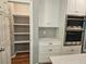Pantry includes shelving, drawers, stainless steel double ovens, and white cabinets at 610 Brington Close, Alpharetta, GA 30022