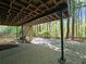 Outdoor patio area with staircase leading to wooded area at 610 Brington Close, Alpharetta, GA 30022