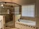 Bathroom features a walk in shower, a large tub, and a bright window at 713 Parkside Dr, Woodstock, GA 30188