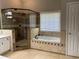 Bathroom with a walk in shower, large soaking tub, and tiled floor at 713 Parkside Dr, Woodstock, GA 30188