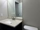 Bathroom featuring a sleek vanity, a neutral countertop, and a large mirror at 713 Parkside Dr, Woodstock, GA 30188