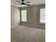 Bright bedroom featuring neutral walls, carpet flooring, and a modern ceiling fan at 713 Parkside Dr, Woodstock, GA 30188