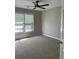 Inviting bedroom with a ceiling fan and two windows providing ample natural light at 713 Parkside Dr, Woodstock, GA 30188