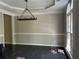 Dining room with decorative molding, neutral walls, and pendant lighting above the dark wood floors at 713 Parkside Dr, Woodstock, GA 30188