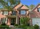 Traditional two-story brick home with black shutters, a front porch, and an attached garage at 713 Parkside Dr, Woodstock, GA 30188