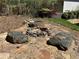 A charming backyard stone fire pit area provides a relaxing space for outdoor gatherings at 713 Parkside Dr, Woodstock, GA 30188