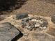 Cozy backyard fire pit surrounded by rocks creates a perfect outdoor entertainment space at 713 Parkside Dr, Woodstock, GA 30188